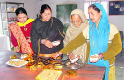Women from Prathal village near the Vaishno Devi shrine make prasad at HESCO in Dehradun