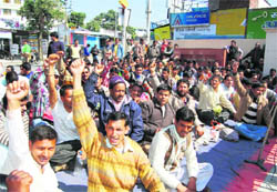 Power employees stage a protest in front of the Urja Bhawan in Dehradun