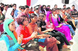 Girl students watch a cultural programme at SGRR (PG) College in Dehradun