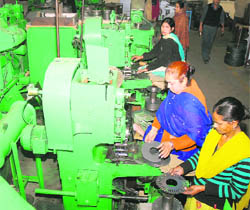 Women operate heavy notching power presses in an industrial unit in Jalandhar.