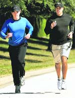 Tiger Woods (R) jogs with an unidentified friend near his home in Windermere on Wednesday.
