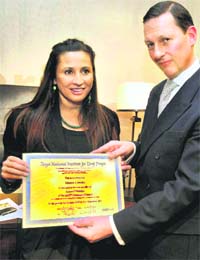 Philanthopist Meera Gandhi receives the certificate of appointment as the Centenary Councillor of Royal National Institute for Deaf People from RNID's Centenary director Philip Bonn at an event in New York