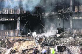 Smoke billows out from a building after an aircraft crashed into it in Texas