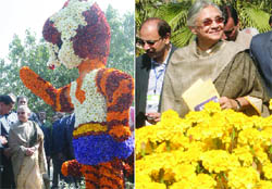 Delhi Chief Minister Sheila Dikshit admires flower-made mascot of the Commonwealth Games Shera and yellow marigolds after inaugurating the 23rd Garden Tourism Festival at the Garden of Five Senses in New Delhi 