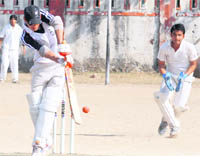 A batsman plays a glance during a match of the first Inter-College Cricket Tournament at Survey Grounds in Dehradun