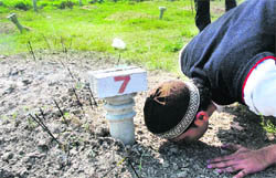 Shabab Anwar offers prayers at the grave of his grandmother Ashraf Unishah at Mehrana near Panipat 