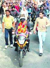Blindfolded Shanker Samrat rides a mobike in Gandhi Nagar in Jammu on Friday.