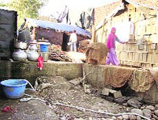 Utensils kept in a row to fetch water in Sher-e-Kashmir Colony.