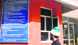A visitor from a remote area of Poonch district at the blood bank of the SMGS Hospital tries to understand information written in English.