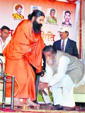 Jharkhand Chief Minister Shibu Soren seeks blessings from yoga guru Swami Ramdev in Ranchi on Friday. 