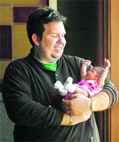 US citizen Brad Fister holds his 23-day-old daughter Ashton in Hyderabad on Friday. Fister and Michael Griebe, a gay couple, paid about $60,000 to a infertility centre for the procedure where a donated egg was fertilised with his sperm and carried to term by an Indian surrogate mother.
