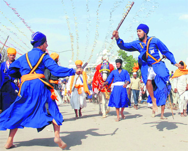 Dressed in cloth and steel, these Nihangs perform mock battles and military exercises at Anandpur Sahib.