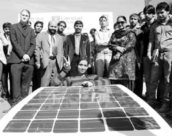 A student displays a solar car manufactured by students of Gurukul Vidyapeeth at Banur on Saturday.