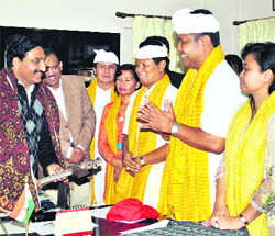 Chief Minister Ramesh Pokhriyal Nishank meets a dance troupe from Bali, Indonesia, in Dehradun on Saturday. 