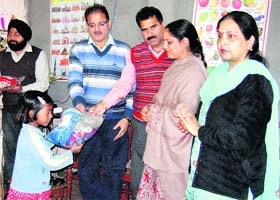 Mayor Kavinder Gupta distributes essential items among orphans under the project Pahl of Damodahar Satri Udhyog in Jammu