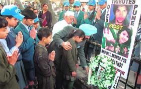 All-India Anti-Terrorist Front chairman MS Bitta and schoolchildren pay tributes to Pune blast victims at Jantar Mantar in New Delhi on Saturday. 