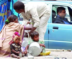 Delhi, a city of contrasts: Some in cars, some on the road