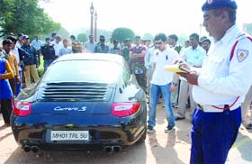 Delhi police challans an overspeeding participant of 'Delhi's first Supercar Show', at Vijay Chowk in New Delhi