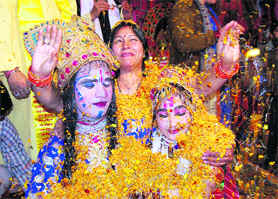 Holi being celebrated with flowers at a temple in Dehradun on Saturday.