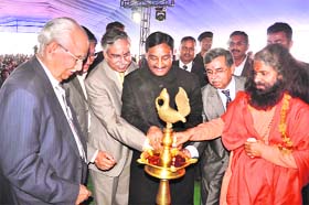 Chief Minister Ramesh Pokhriyal Nishank, Swami Chidanand Muni, Hero Honda Director Brij Mohan Munjal at a function in Haridwar