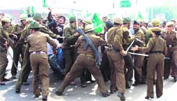 Policemen cane charge PDP activists in Jammu on Monday. 