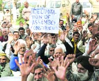Members of the J&K PoK Refugee Front hold a demonstration in support of their demands in Jammu on Monday. 