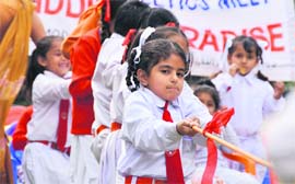 Students of Kiddies Paradise participate in a tug of war during their sports day in Ludhiana on Monday.