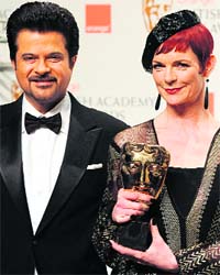 Actor Anil Kapoor poses with Sandy Powell after she received a British Academy of Film Award for 'costume design' for film 'The Young Victoria' at the Royal Opera House in central London