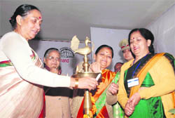 Uttarakhand Governor Margaret Alva lights a lamp to inaugurate a workshop on the 