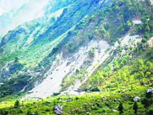 A view of denuded hills owing to reckless cutting of trees by power companies.