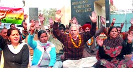 Staff of Hans Raj Mahila Maha Vidyalaya hold a dharna outside the college gate in Jalandhar