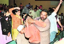 A cop uses force against a protesting ETT teacher during a function in Mohali on Tuesday