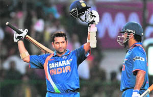 Sachin Tendulkar celebrates scoring a world record breaking double century at the Captain Roop Singh Stadium in Gwalior on Wednesday.