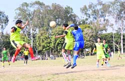 Players vie for the ball during the Narayan Gurung Memorial Football Tournament in Dehradun on Thursday. 