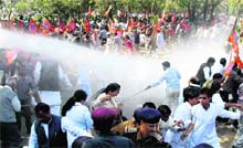 The police uses water canons to disperse BJP activists from Haryana protesting against price rise in Sector 18, Chandigarh, on Thursday;