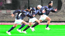 Get set and go: India captain Rajpal Singh (R) warms up with teammates prior to their practice match against Netherlands in New Delhi on Thursday.