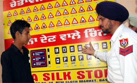 A traffic cop explaining traffic rules and signs to a minor boy, who has been awarded punishment by the Juvenile Justice Board, at the traffic police office in Bathinda on Friday.