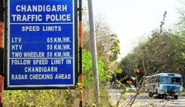 A sign on the road leading to the PGI and the PU displays a speed limit of 65 kmph in Chandigarh.