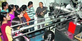 A scientist explains the working of a technical instrument to students in Chandigarh on Friday.