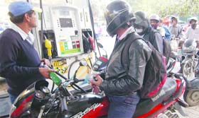 FEELING THE PINCH: Motorcyclists queue up to get their tanks filled at a petrol pump in New Delhi