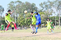 Players vie for the ball at Narayan Gurung Memorial Football Tournament at the Mahendra Ground in Dehradun on Friday.