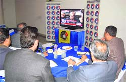 Industrialists sit glued to a television set listening to the Budget speech in Dehradun on Friday.