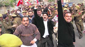 NC activists raise slogans against the PDP in Jammu on Friday.