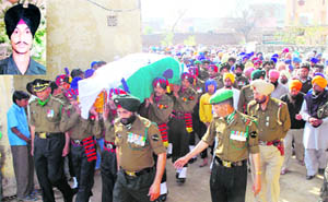 The body of jawan Lakhvir Singh (inset), who died in an encounter with militants in Jammu and Kashmir, arrives in Charik village in Moga district on Friday.