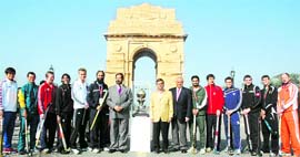 South Koreas captain CH Jong Vok, Australias Jamie Dwyer, Englands Barry Middleton, Canadas Ken Pereira, Germanys Maximillian Muller, Indias Rajpal Singh, Pakistans Zeeshan Ashraf, Spains Pablo Amat, Argentinas Matias Vila, New Zealands Phillip Burrows, South Africas Austin Smith, Netherlands Teun de Nooijer pose with the World Cup Trophy in front of India Gate in New Delhi on Friday. Tribune photo: Manas Ranjan Bhui