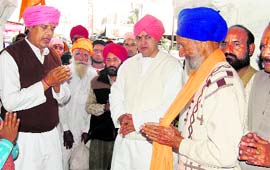 Mahant Devinder Dass of Guru Ram Rai Darbar Sahib receives the first sangat from Punjab for the Jhanda Sahib Mela in Dehradun on Saturday.
