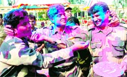 BSF jawans celebrate Holi at the Suchetgarh border post on Saturday