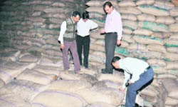 Officials of the food and supplies department check the sugar lying in a godown at Seera village in Ludhiana 