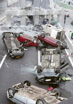 Crushed cars in a parking lot in Concepcion city after Saturday mornings quake.