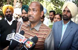 Gora Lal, a member of the state committee of the Dera Sacha Sauda, along with other Dera followers speaking to media at the DCs residence in Bathinda on Sunday